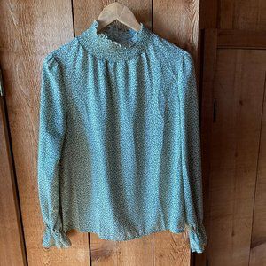 Green blouse with white pattern